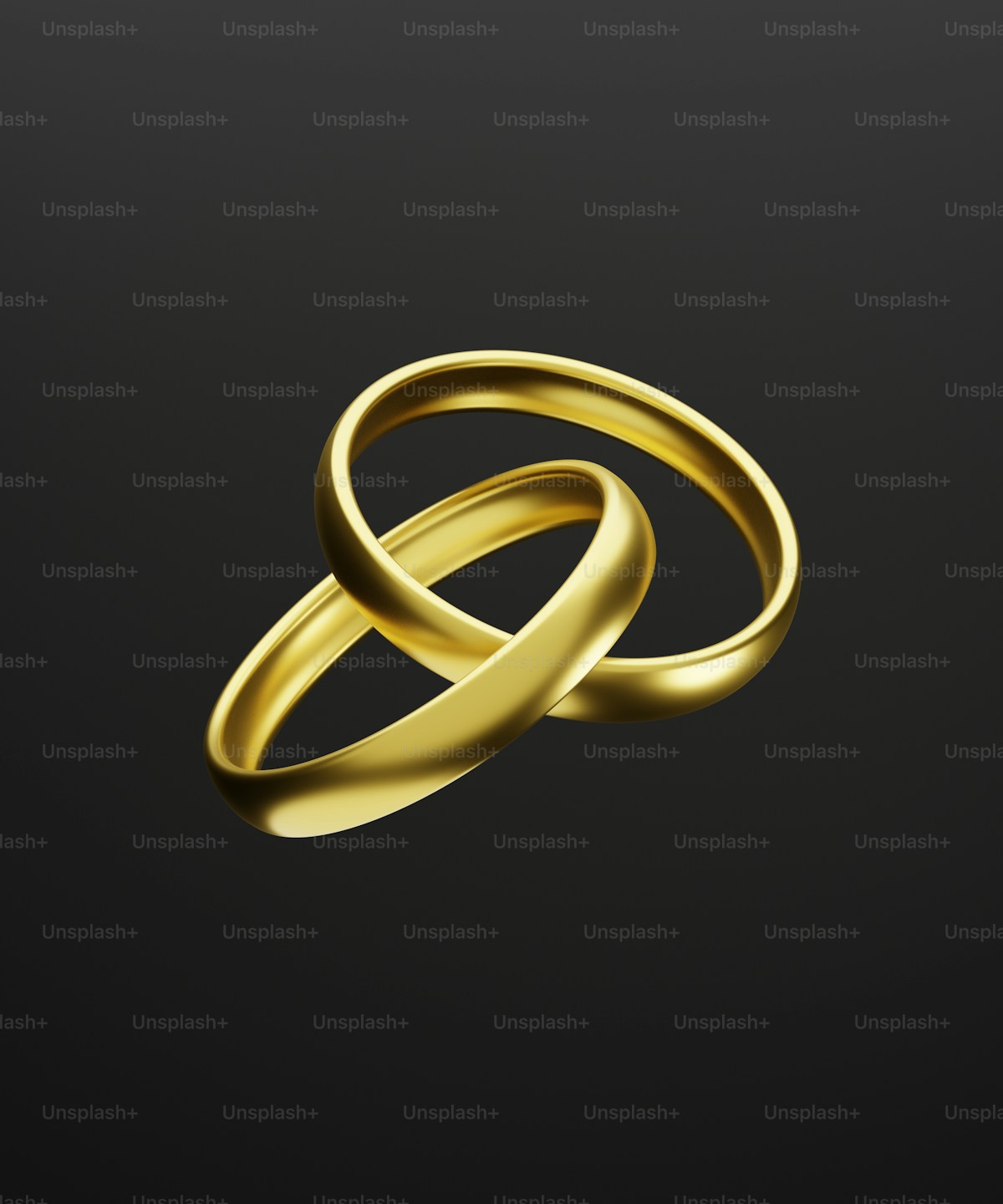 Two gold wedding bands on a black background